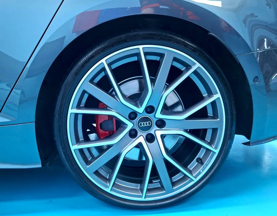 Close-up of the Audi S5 alloy wheel with a red brake caliper.