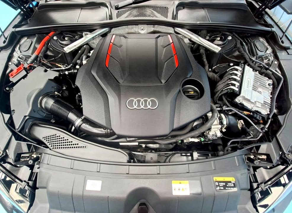 Engine bay of the Audi S5 after cleaning, with the engine cover in view.