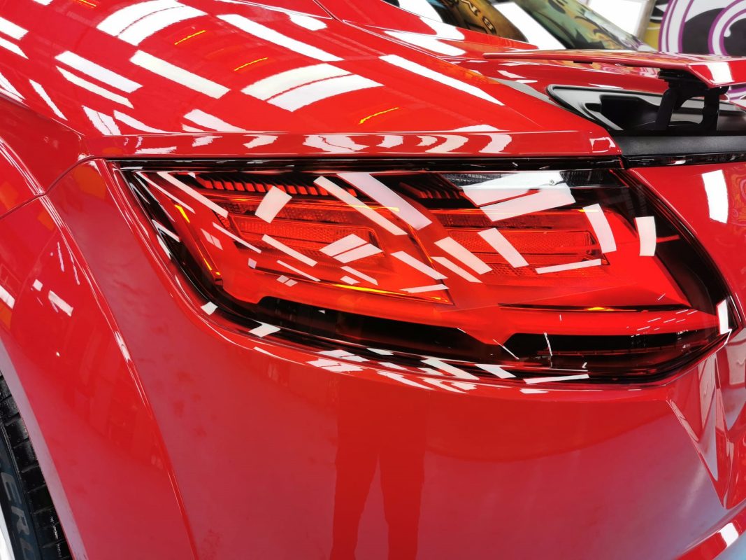 The coated bonnet of the Audi TT Coupe under workshop lighting.
