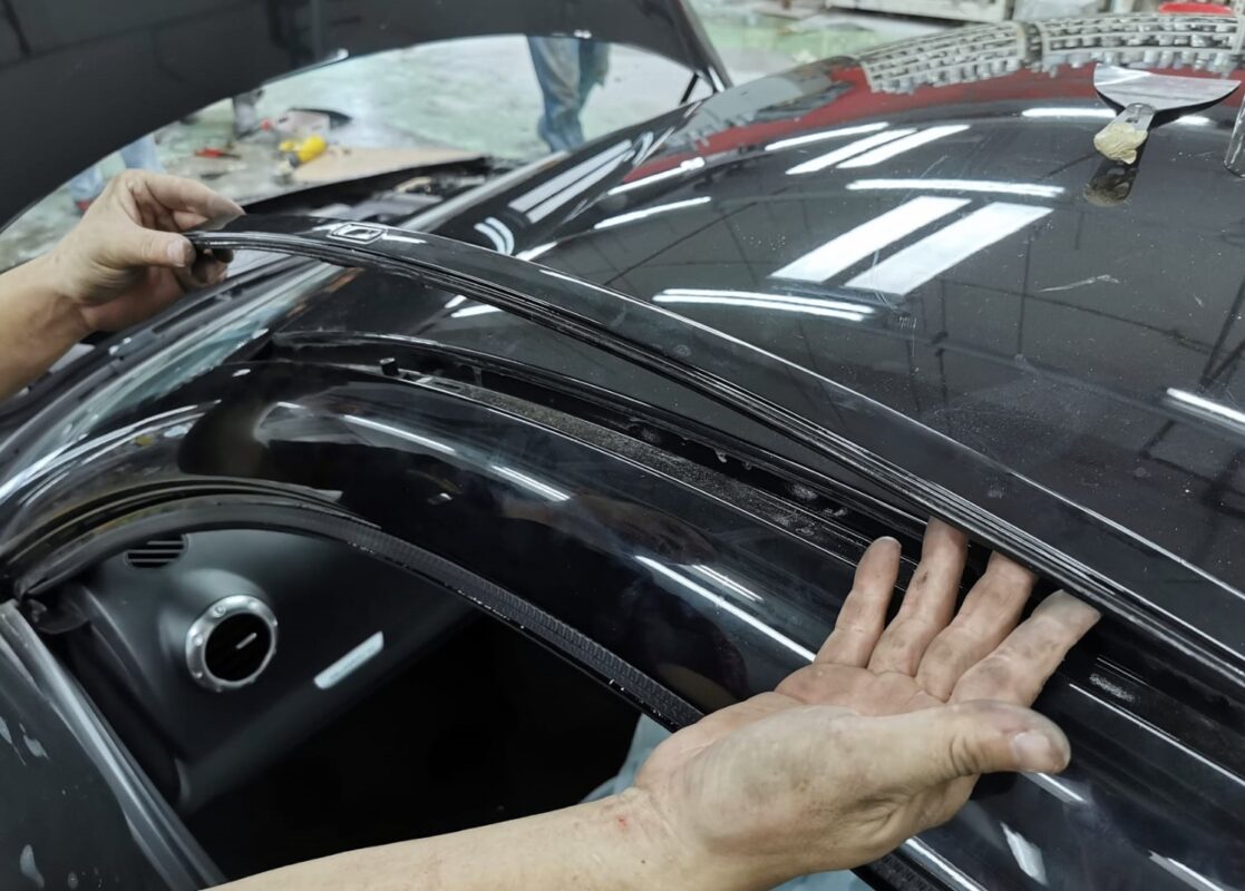 Trim being lifted off the Audi TT during strip-down.