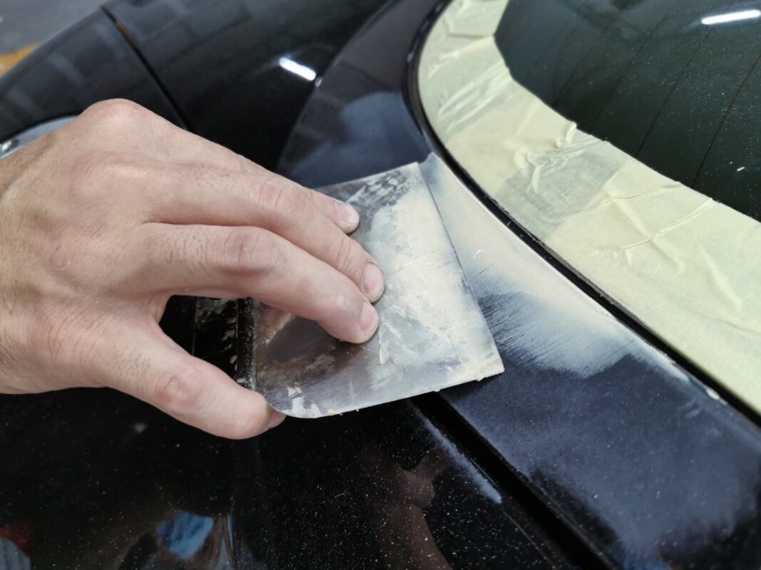 Machine-polishing the Audi TT's roof to bring up the gloss.