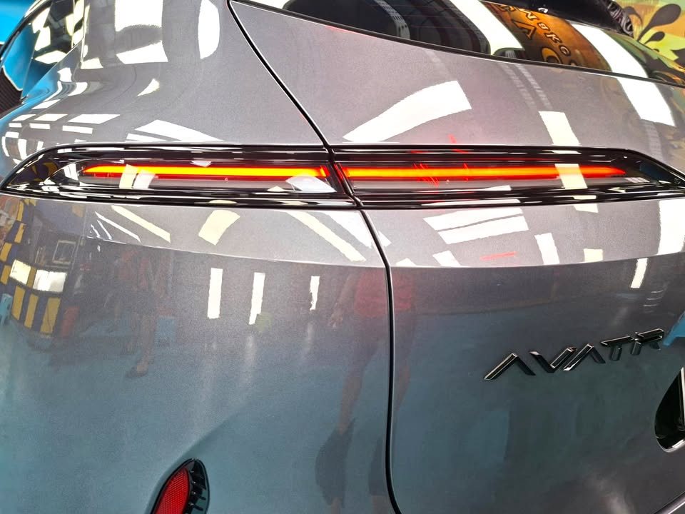 Close-up of the lit tail light bar and Avatr badge on the rear panel.