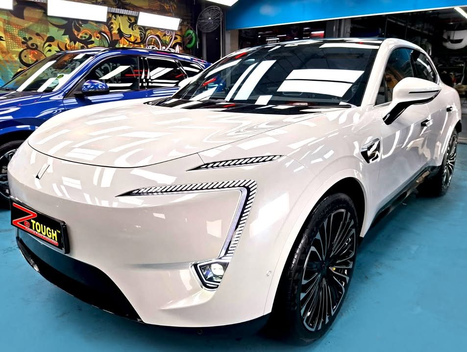 White Avatr 11, front three-quarter view, in the Revol Carz Makeover workshop after its ZeTough Ceramic coating.