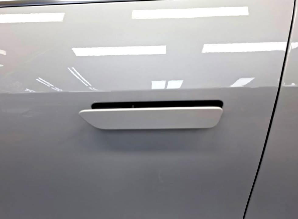White door panel with flush door handle.