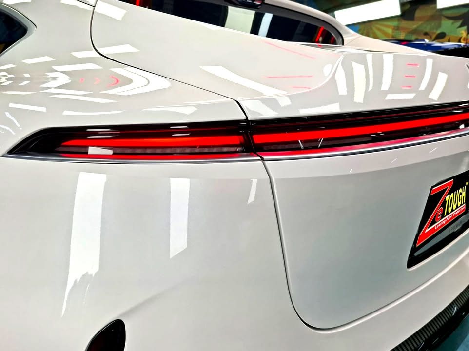 Close-up of the red rear light bar across the white tailgate.