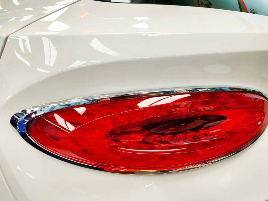 The coated bonnet of the Bentley Bentayga V8 under workshop lighting.
