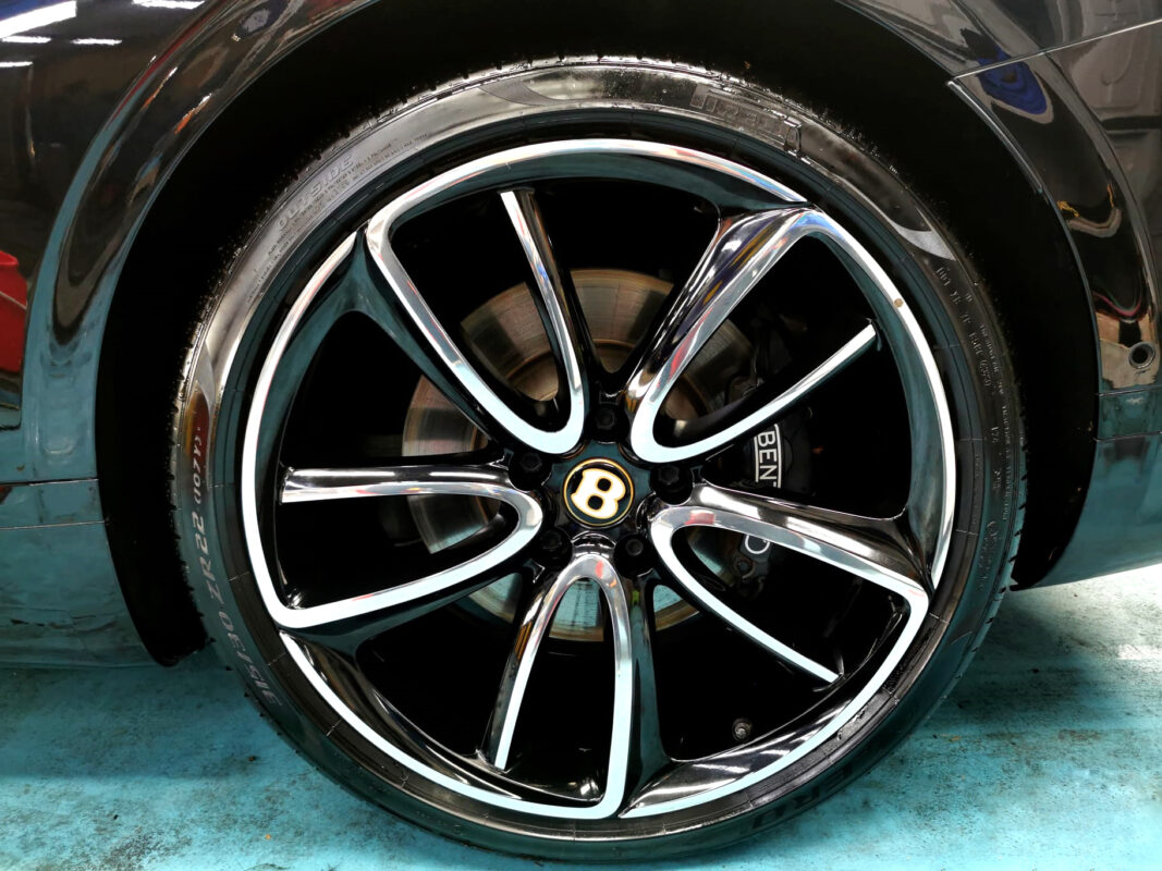 The coated bonnet of the Bentley Continental under workshop lighting.