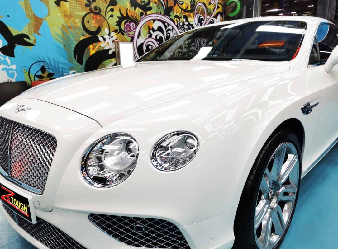 The white Bentley Continental from a side angle after the titanium coating.