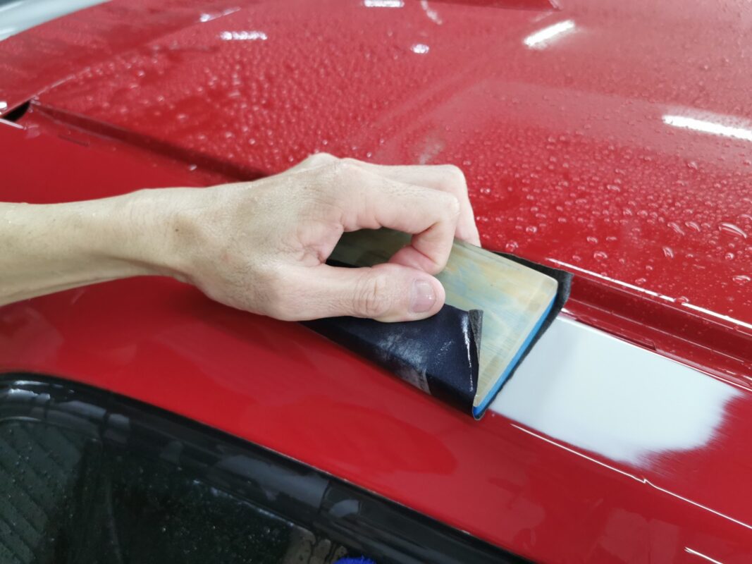 A second round of wet sanding on the BMW 1 Series, refining the surface further.