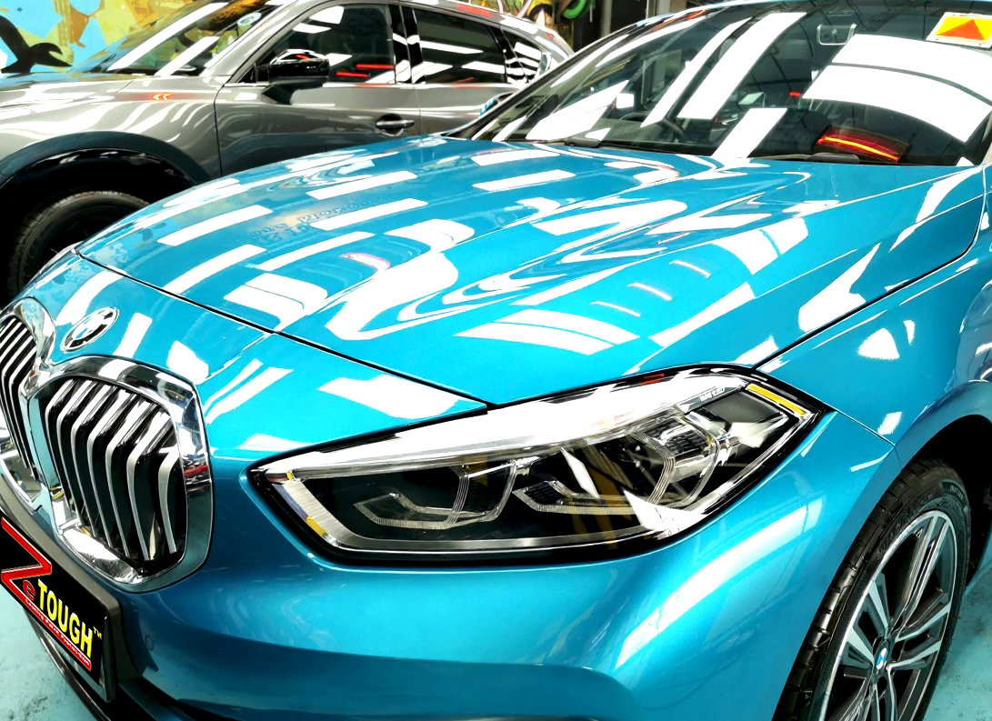 The BMW 1 Series's coated paintwork under workshop lighting.