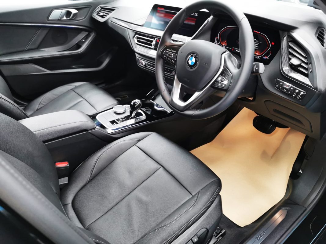 The BMW 1 Series parked in the workshop, freshly coated.