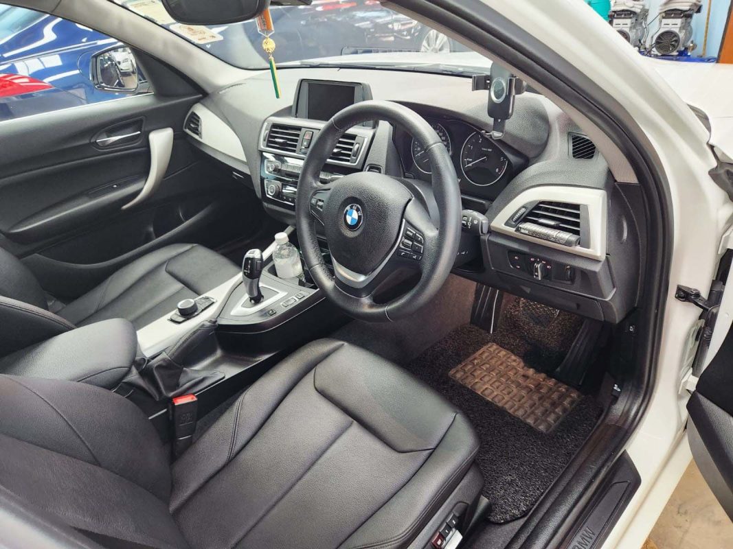 The BMW 116d parked in the workshop, freshly coated.