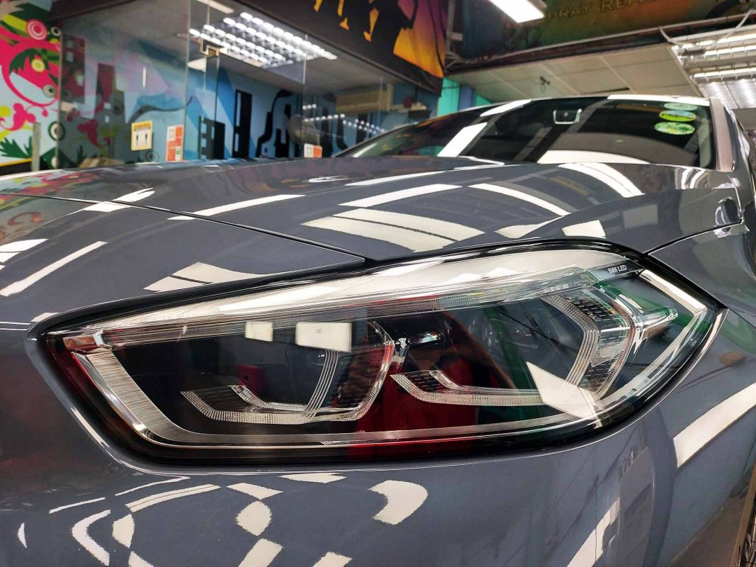 The 116i's coated paintwork showing clean reflections.