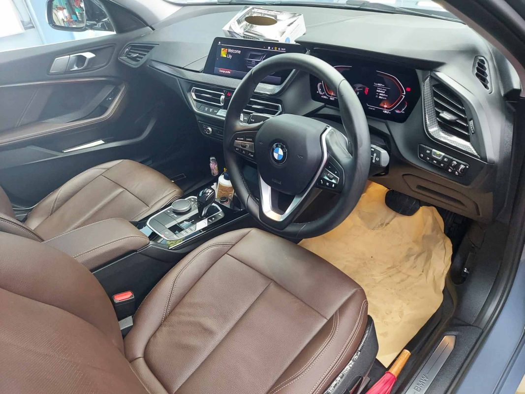 The BMW 116i parked in the workshop, freshly coated.