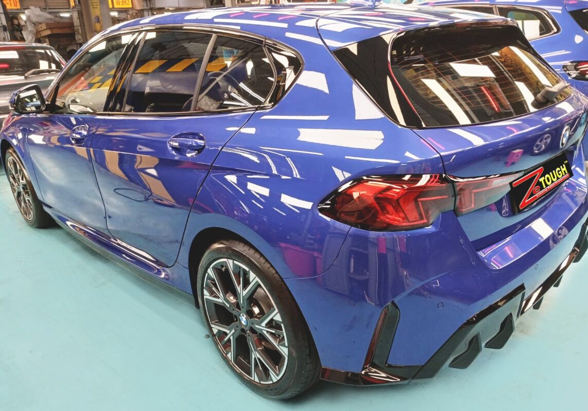 Rear quarter of the BMW 116i, glossy and protected.