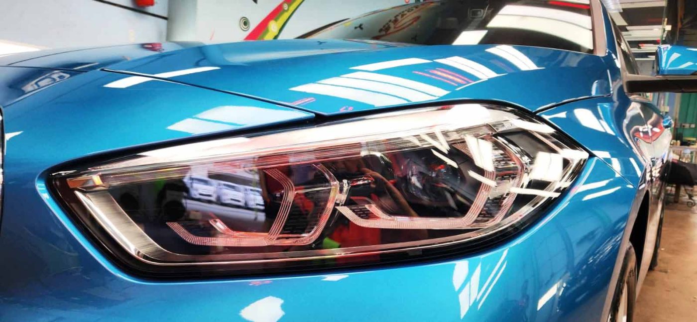 The 116i's coated paintwork showing clean reflections.