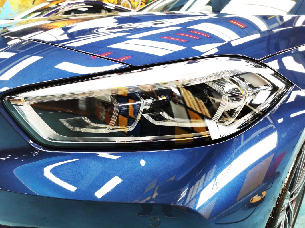 The 116i's coated paintwork showing clean reflections.