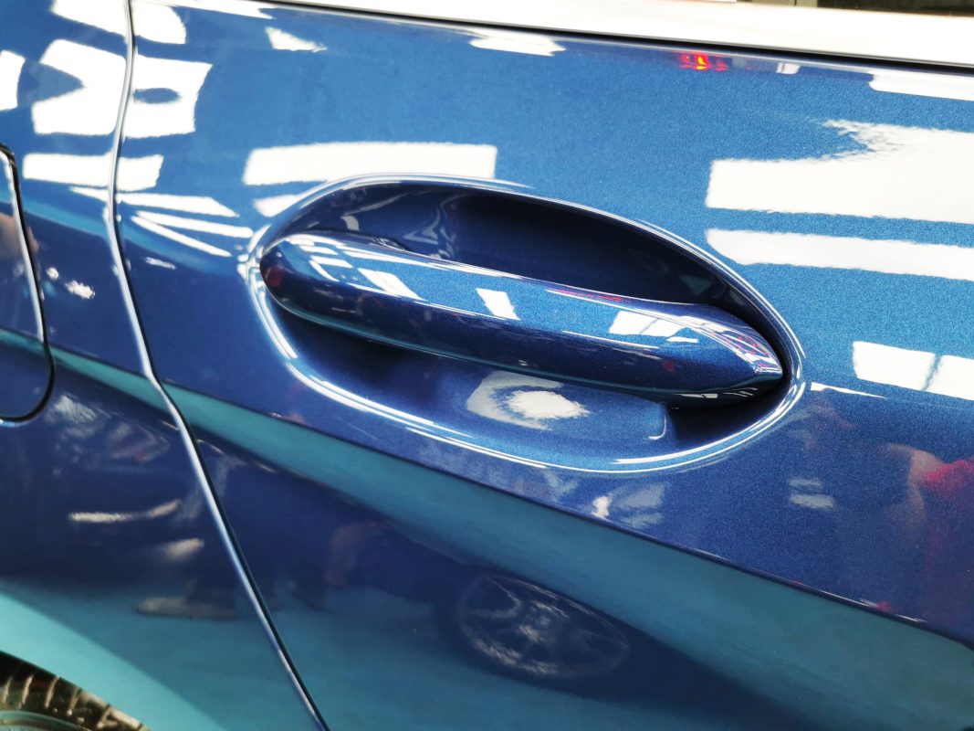 The BMW 116i parked in the workshop, freshly coated.