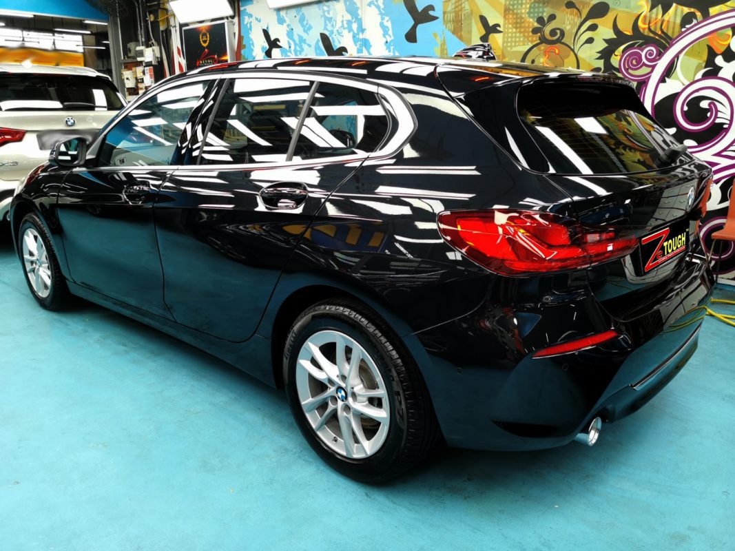 The BMW 116i parked in the workshop, freshly coated.