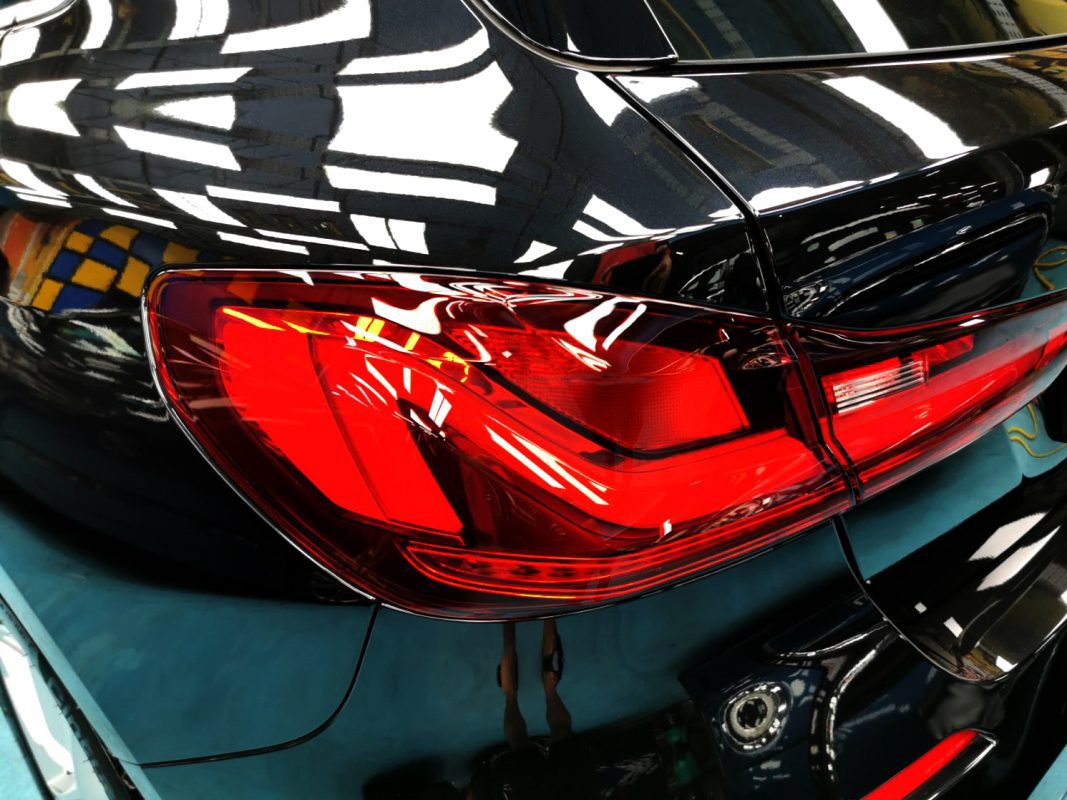 Rear quarter of the BMW 116i, glossy and protected.