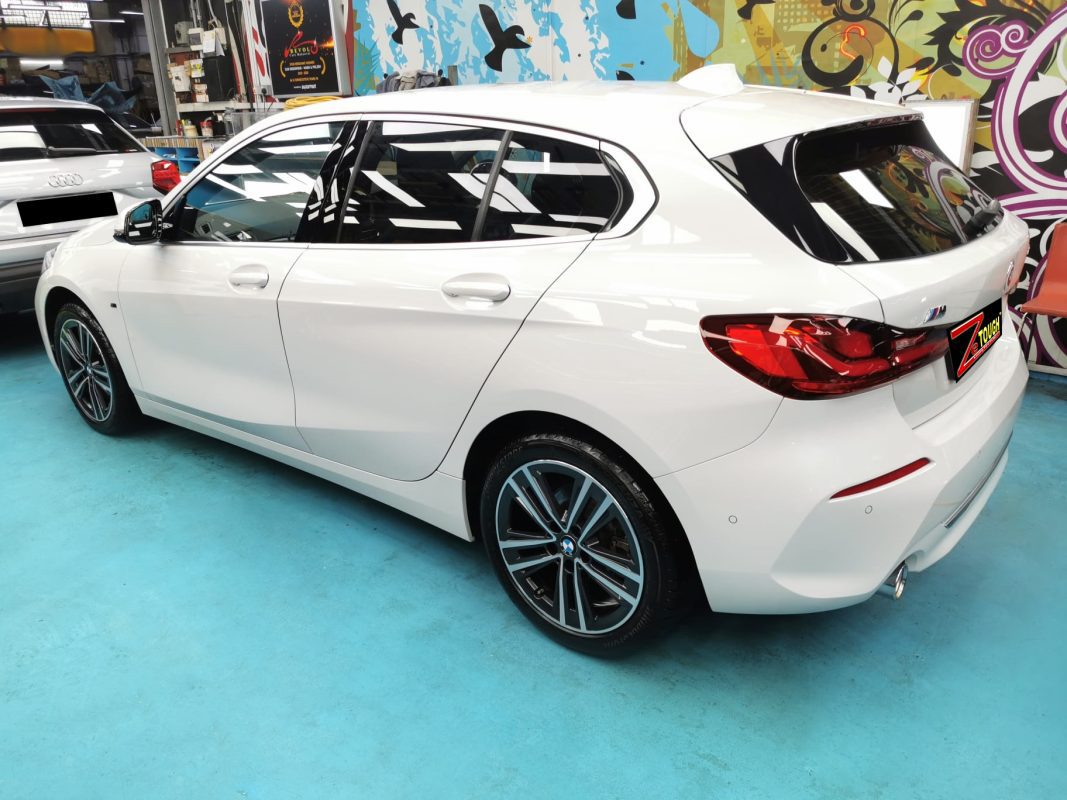 Rear quarter of the BMW 116i, glossy and protected.