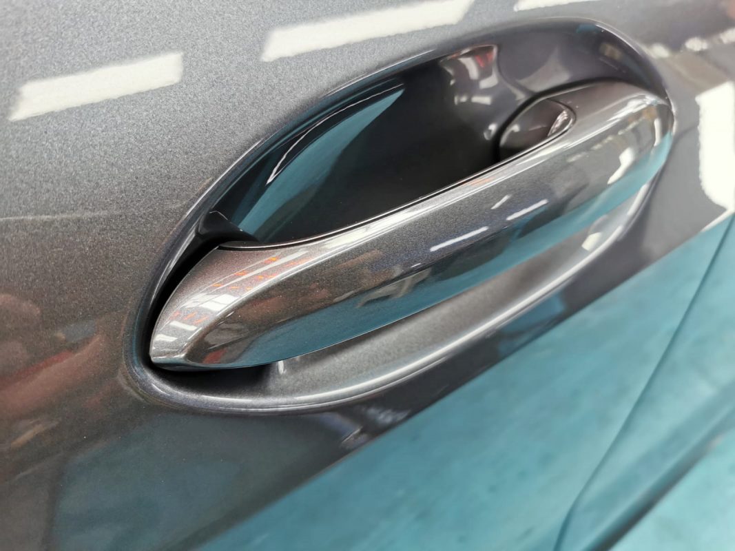The BMW 118i parked in the workshop, freshly coated.