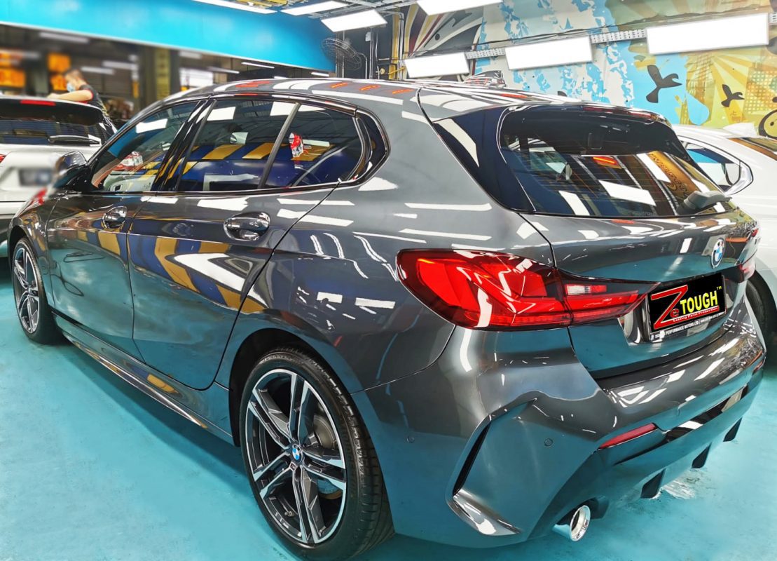 Rear quarter of the BMW 118i, glossy and protected.