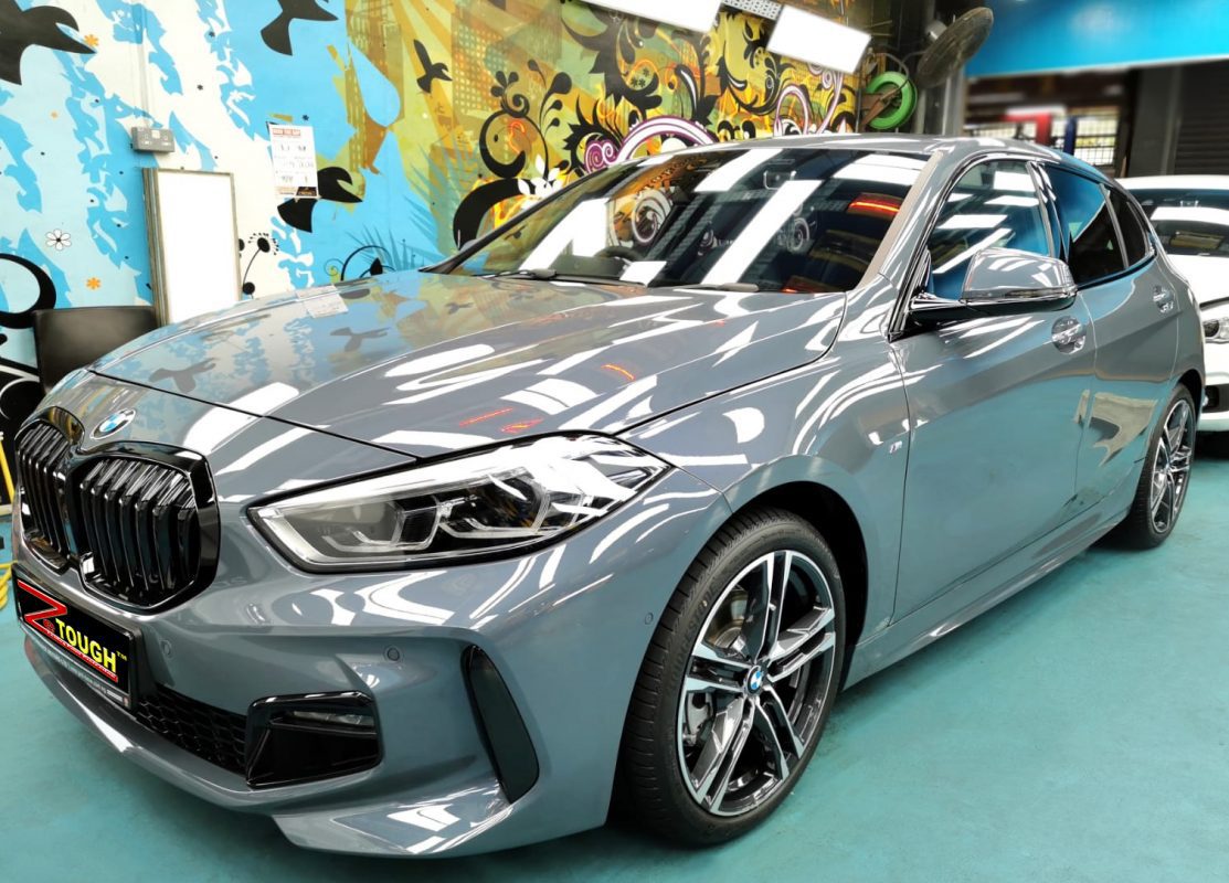 The 118i's coated paintwork holding clean reflections.