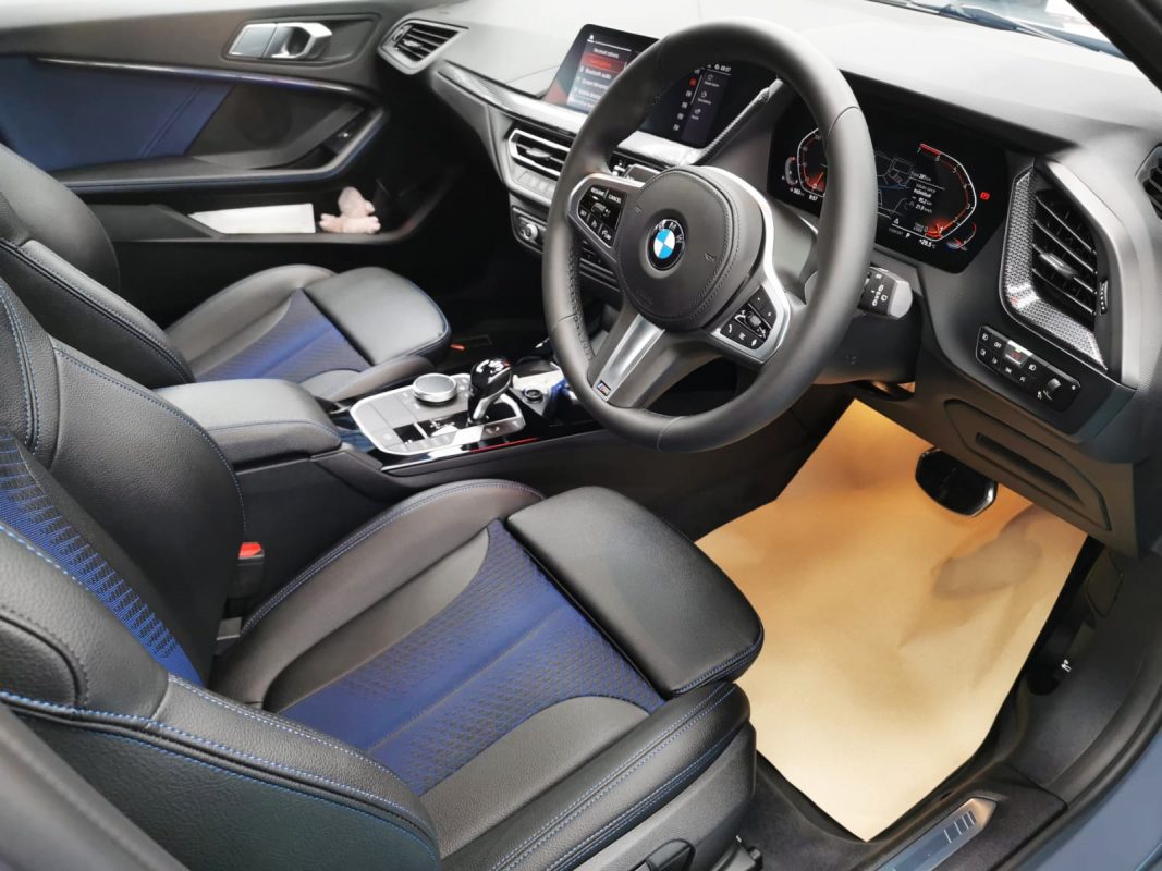 The BMW 118i parked in the workshop, freshly coated.