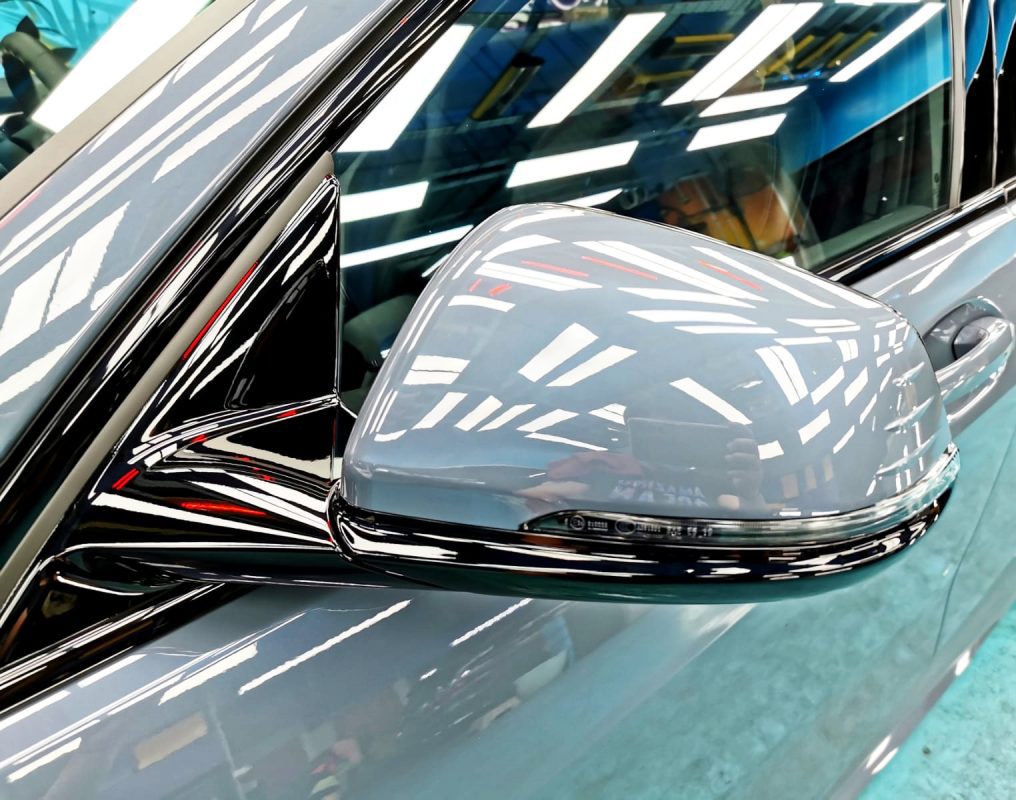 Rear quarter of the BMW 118i, glossy and protected.