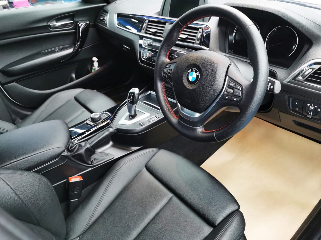 The BMW 118i parked in the workshop, freshly coated.