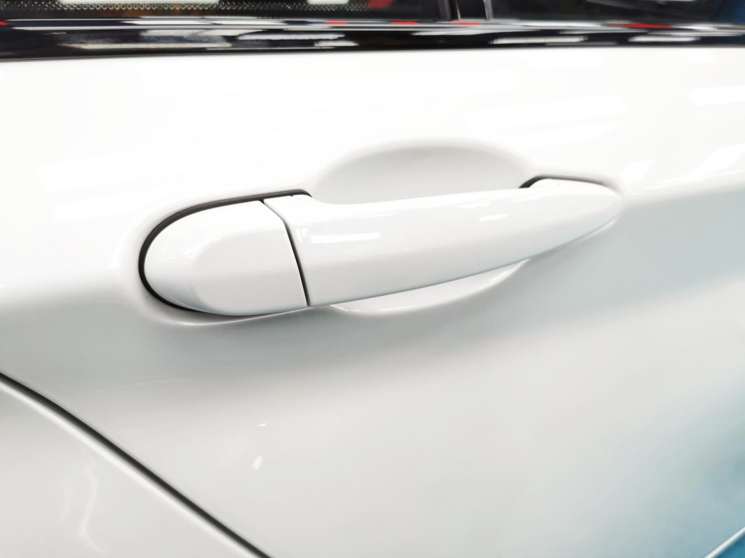 Front three-quarter view of the BMW 118i after coating.