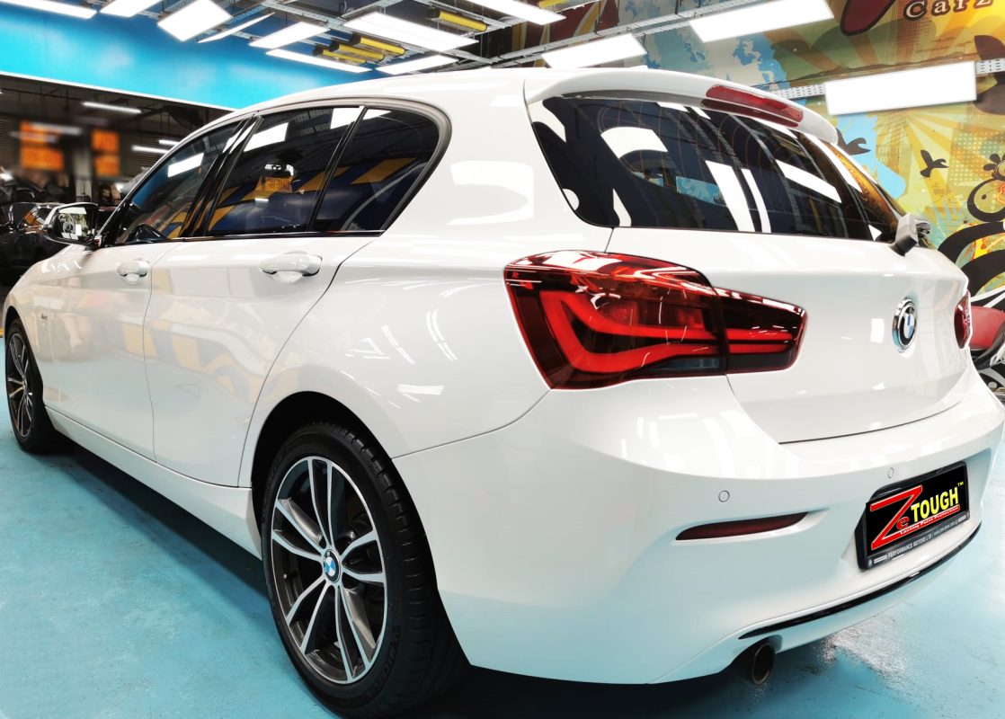 Rear quarter of the BMW 118i, glossy and protected.