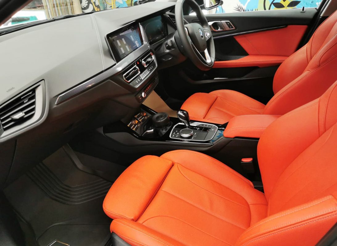 The BMW 118i parked in the workshop, freshly coated.