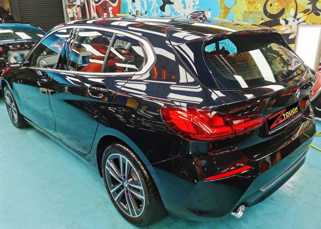 Rear quarter of the BMW 118i, glossy and protected.