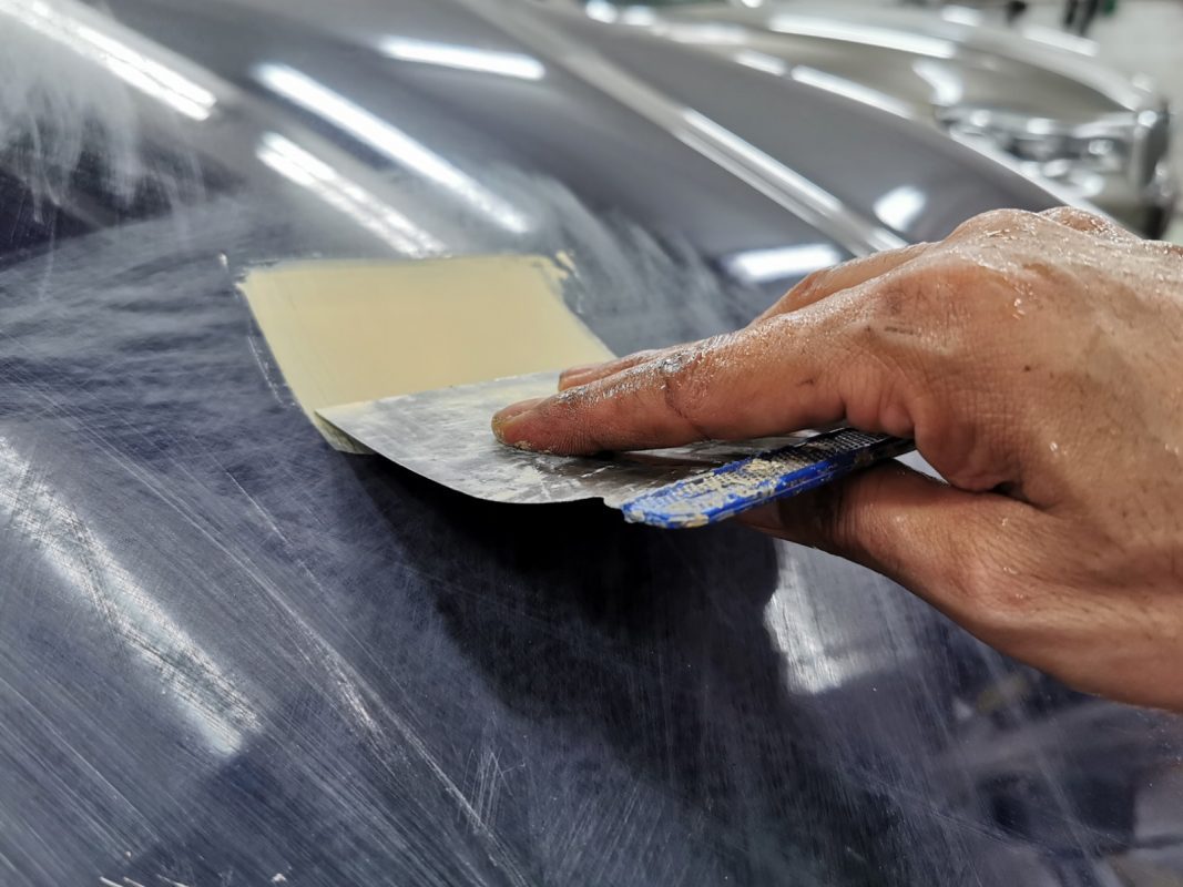 The body of the BMW 2 Series being scanned and patched for imperfections.
