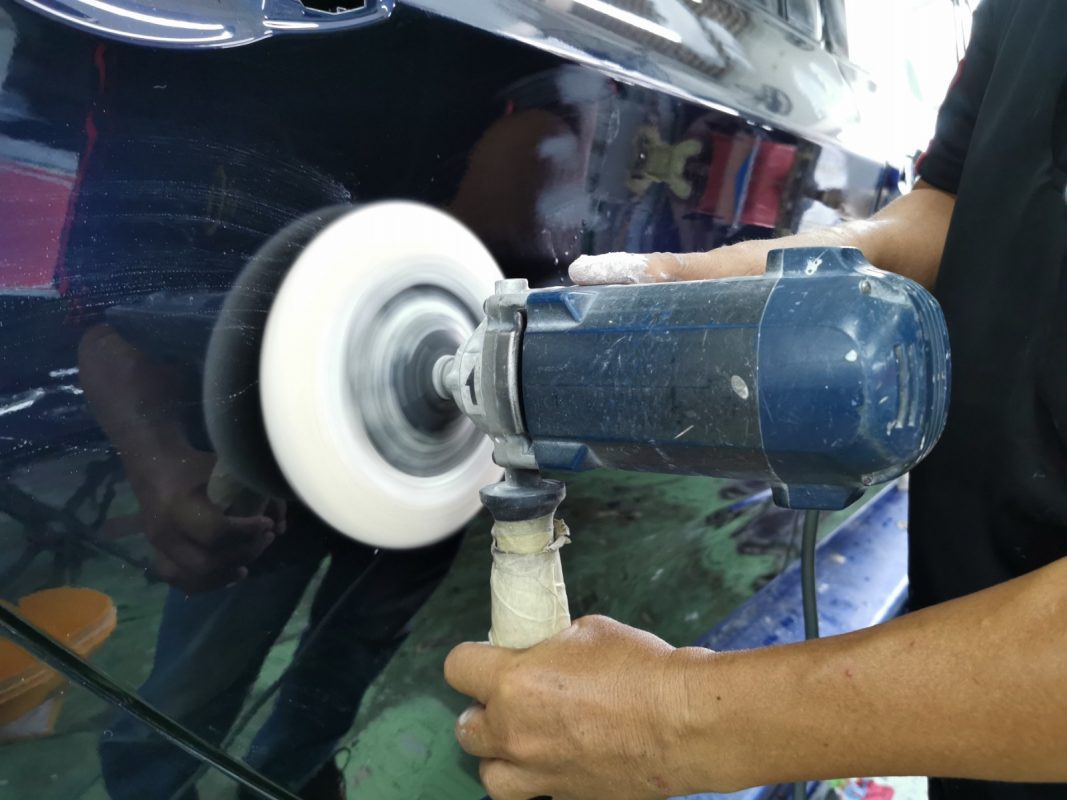 Polishing the new paint on the BMW 2 Series to bring up the shine.