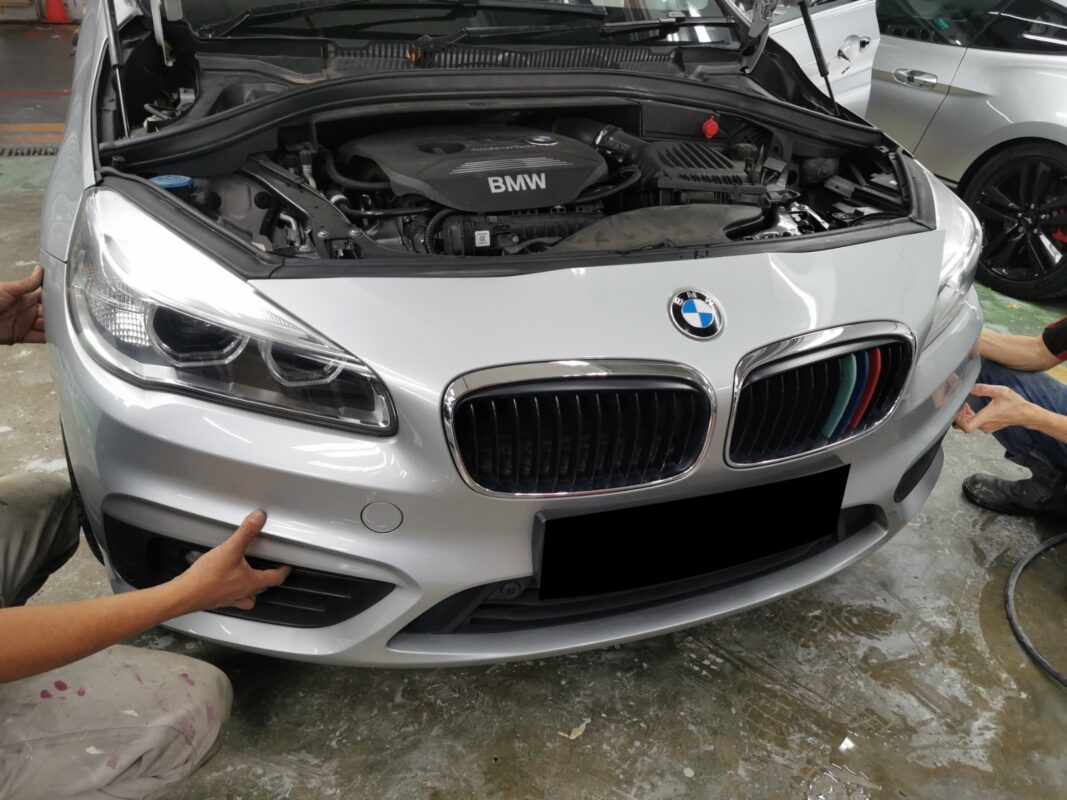 The BMW 2 Series front end with parts removed during strip-down.