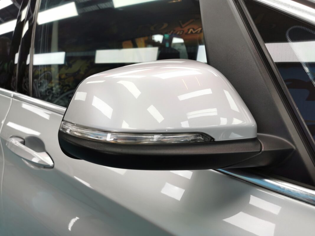 The resprayed door mirror on the finished BMW 2 Series.