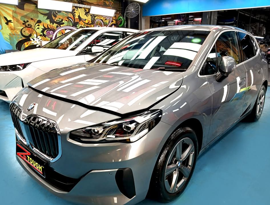 Grey BMW 2 Series front three-quarter view in the Revol Carz workshop after ZeTough Ceramic coating.