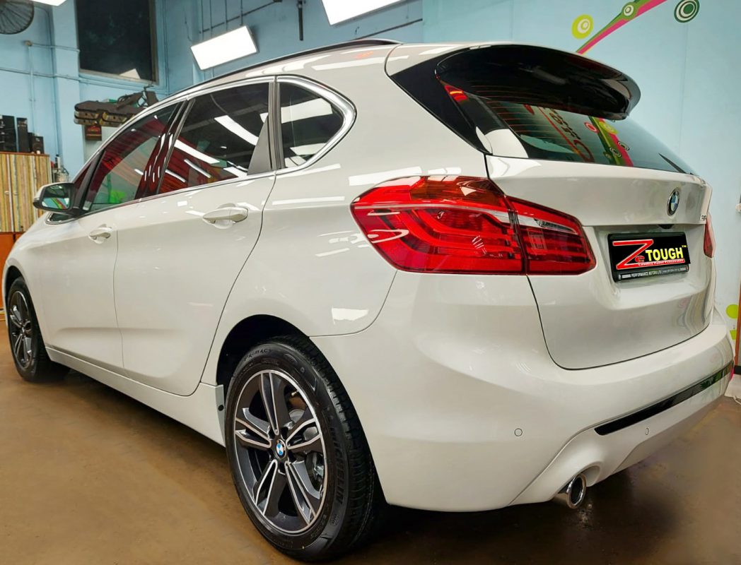 Rear quarter of the BMW 216i, glossy and protected.