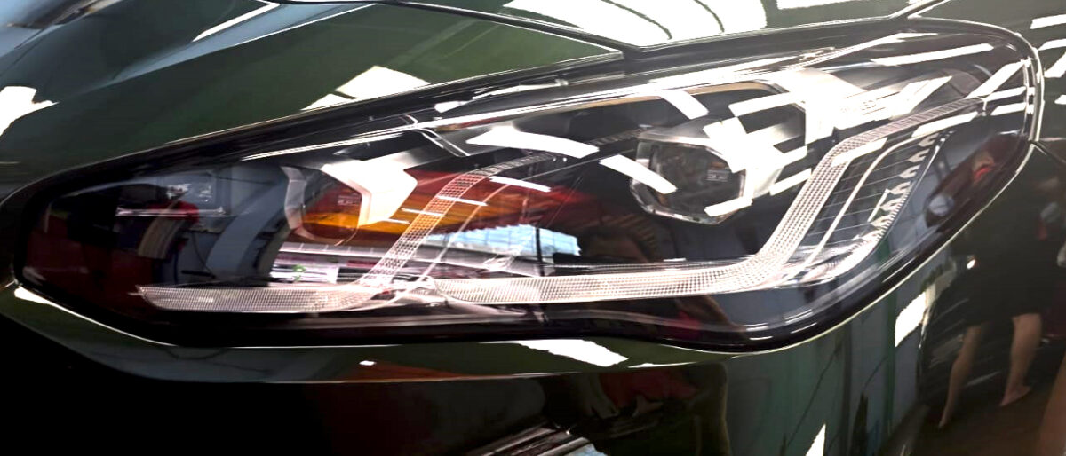 The BMW 216i's coated paintwork showing clean reflections.