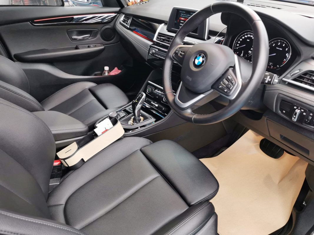 The BMW 216i parked in the workshop, freshly coated.