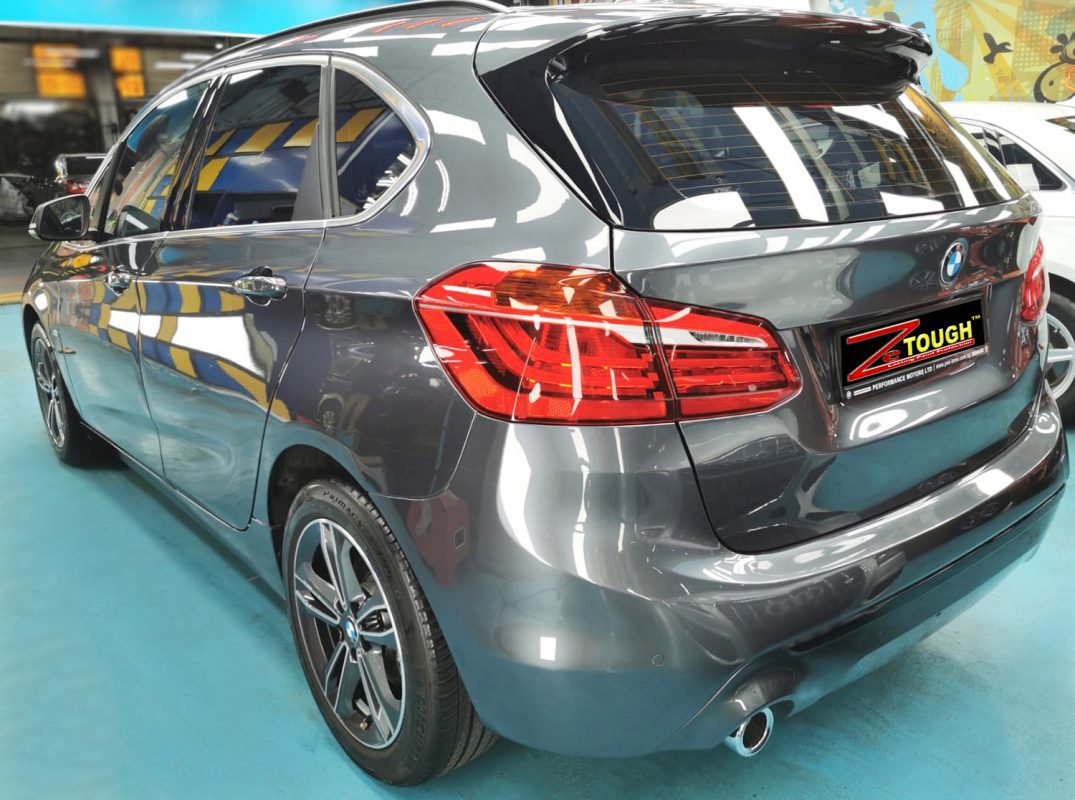 Rear quarter of the BMW 216i, glossy and protected.