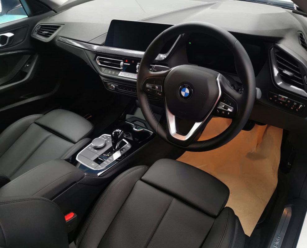 The BMW 216i parked in the workshop, freshly coated.