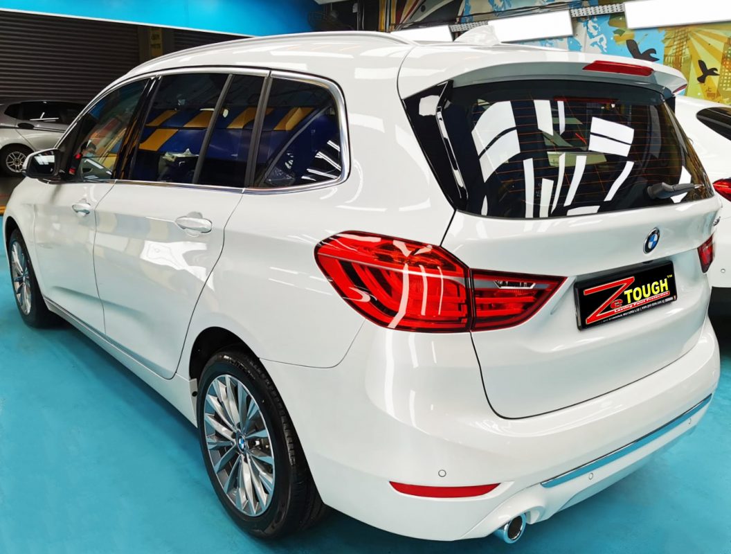 Rear quarter of the BMW 216i Gran Tourer, glossy and protected.