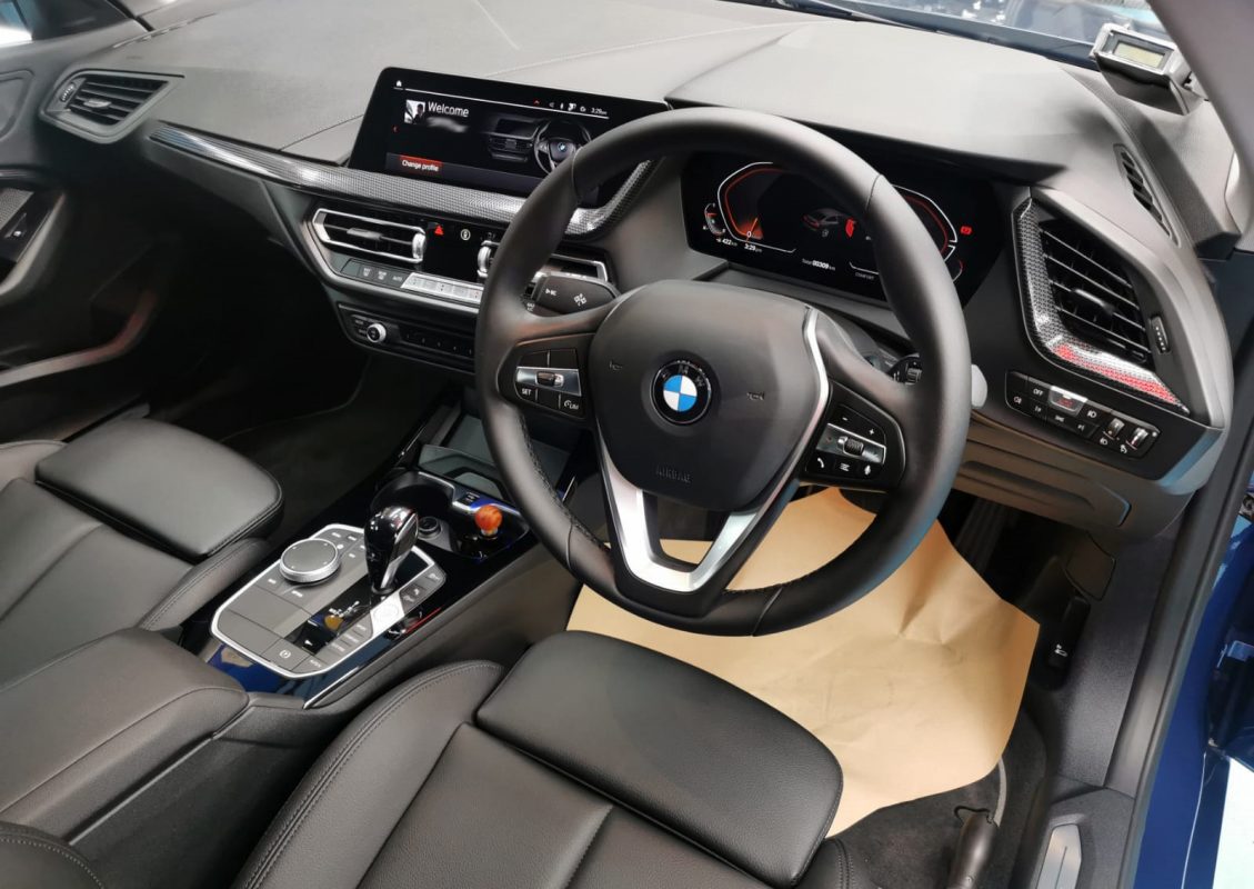The BMW 216i parked in the workshop, freshly coated.