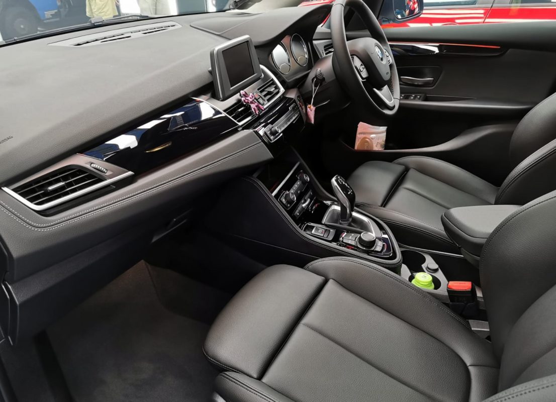 The BMW 216i parked in the workshop, freshly coated.