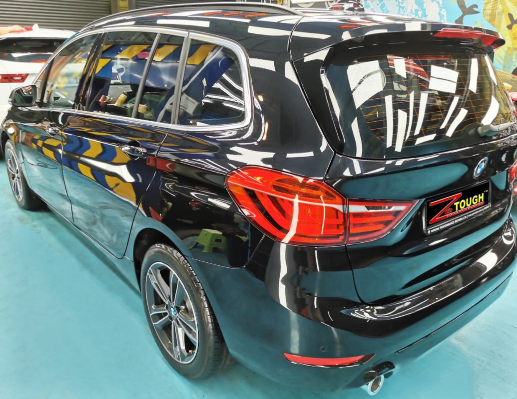Rear quarter of the BMW 216i, glossy and protected.