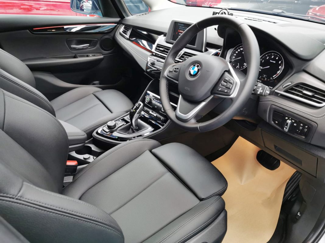 The BMW 216i parked in the workshop, freshly coated.